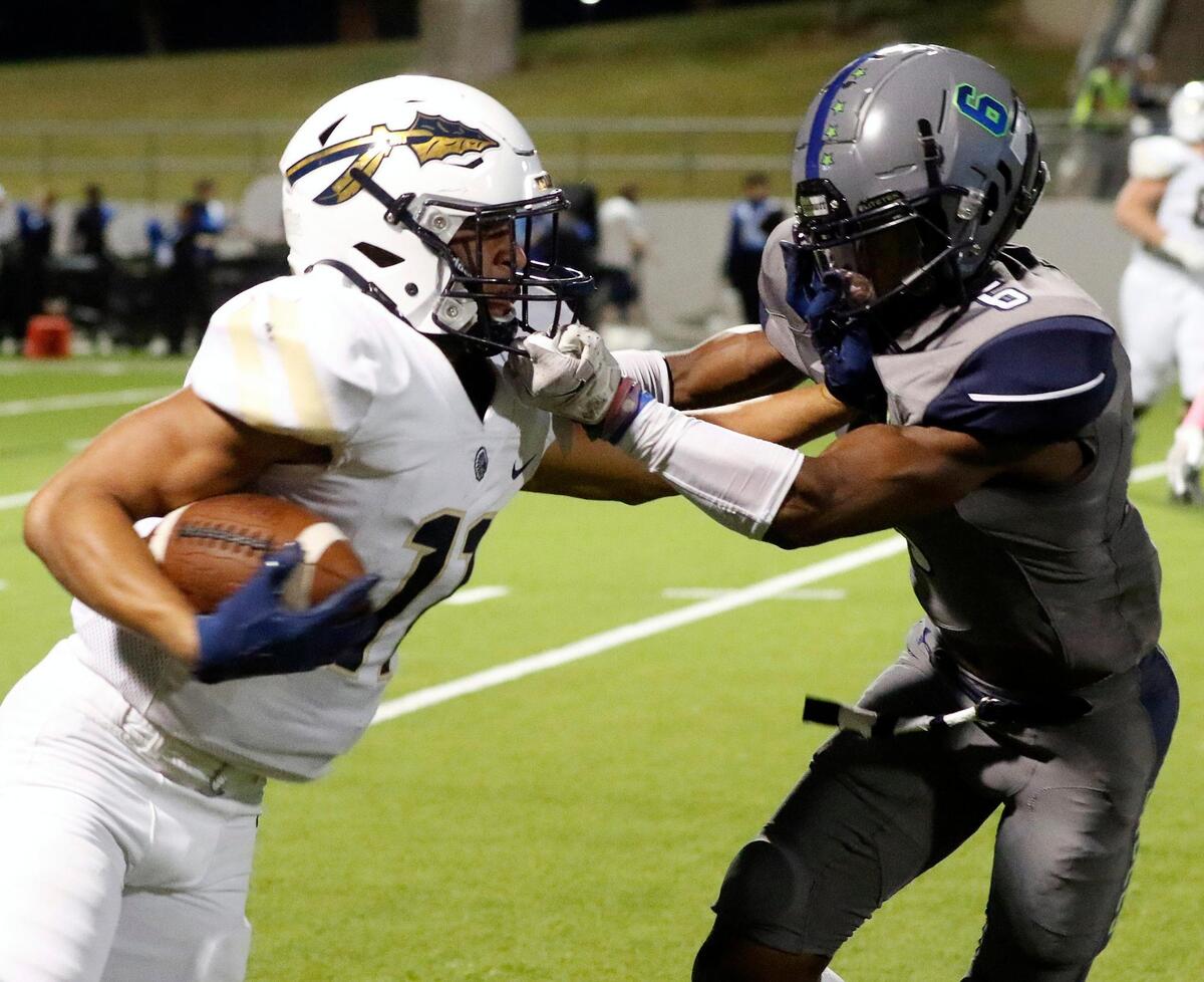 Keller wide receiver Amarion Henry (11) is forced out of bounds by Eaton corner back Royal Evans (6) in a high school district 4-6A football game at NWISD Stadium in Justin, Texas, Friday Oct. 08, 2021. Keller led Eaton 21-10 at the half. (Special to the Star-Telegram Bob Booth)