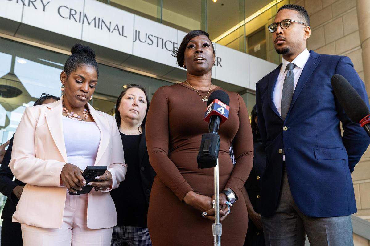 Crystal Mason, center, and her attorneys speak to the media gathered regarding her acquittal in a high-profile voting rights case at the Tim Curry Criminal Justice Center in Fort Worth on Friday, March 29, 2024. The Texas Second Court of Appeals reversed Mason’s conviction on Thursday evening where she had faced five years in prison for submitting a provisional ballot in Tarrant County in 2016 that was never counted as a vote.