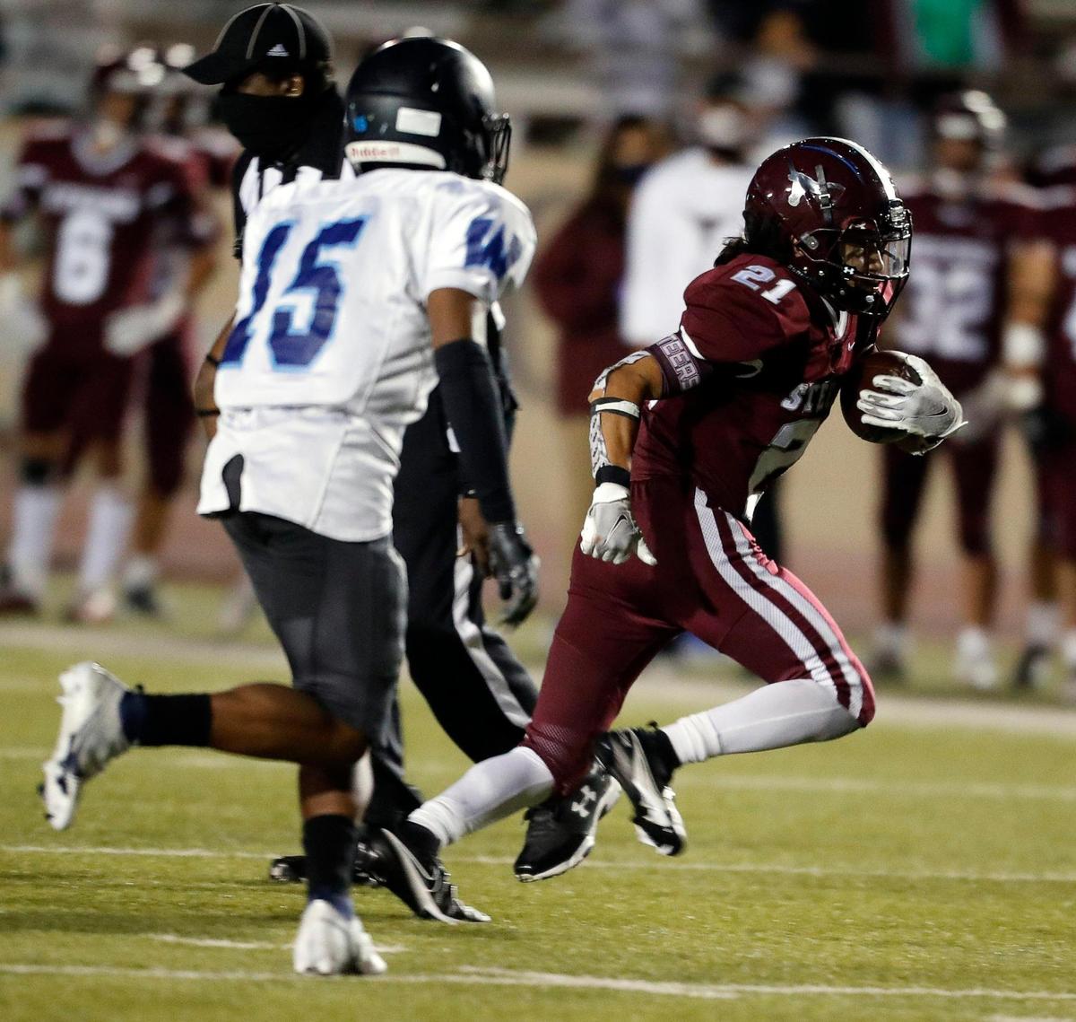 North Side running back Jorge Aguirre (21) runs away from O.D. Wyatt middle linebacker Randolph Parks (15) during a high school football game at Farrington Field in Fort Worth Texas, Friday, Oct. 30, 2020. North Side defeated O.D. Wyatt 43-26. (Special to the Star-Telegram Bob Booth)