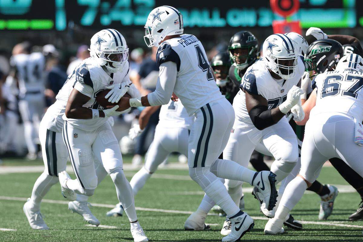 Oct 5, 2025; East Rutherford, New Jersey, USA; Dallas Cowboys quarterback Dak Prescott (4) hands off to Dallas Cowboys wide receiver Ryan Flournoy (19) during the first half at MetLife Stadium. Mandatory Credit: Vincent Carchietta-Imagn Images