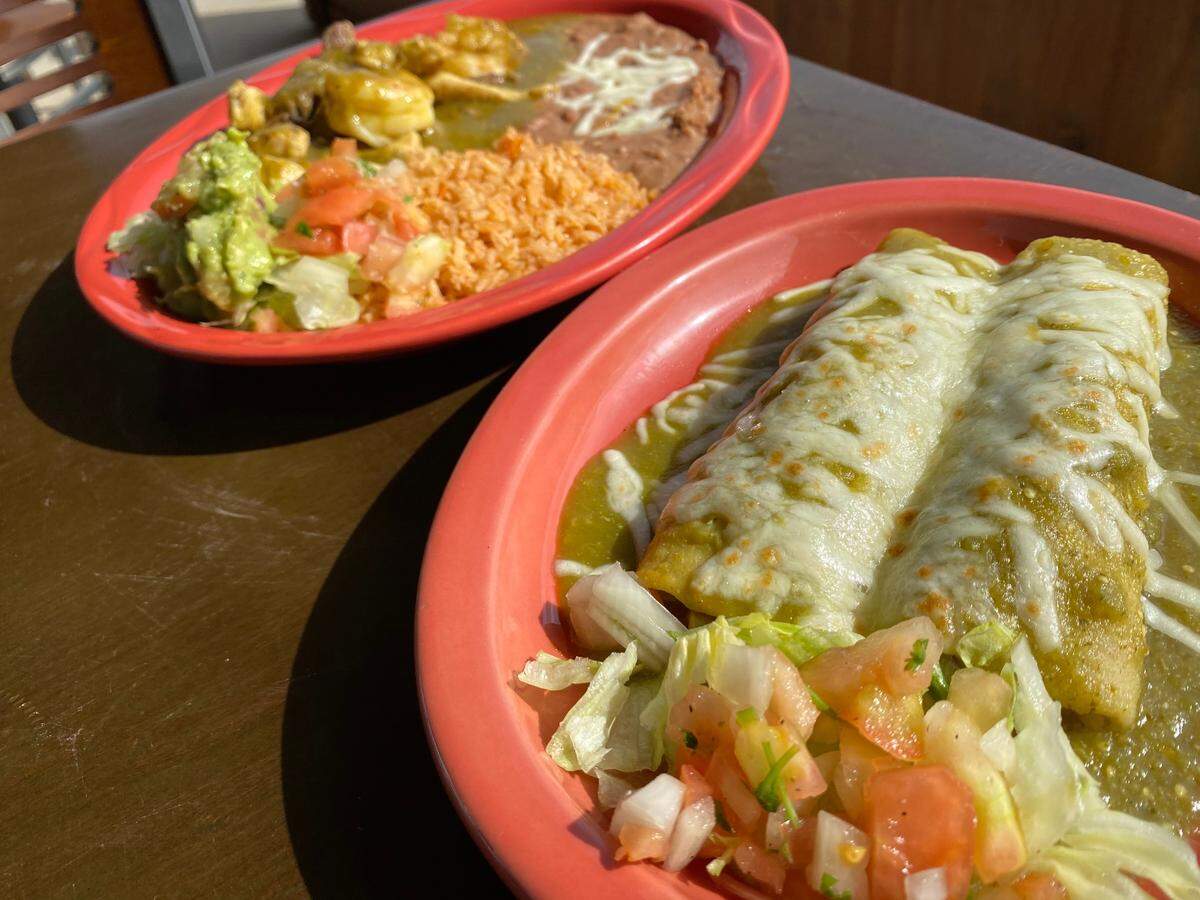 Green chicken enchiladas, right, and fajitas in green sauce at Josefina’s in River Oaks.