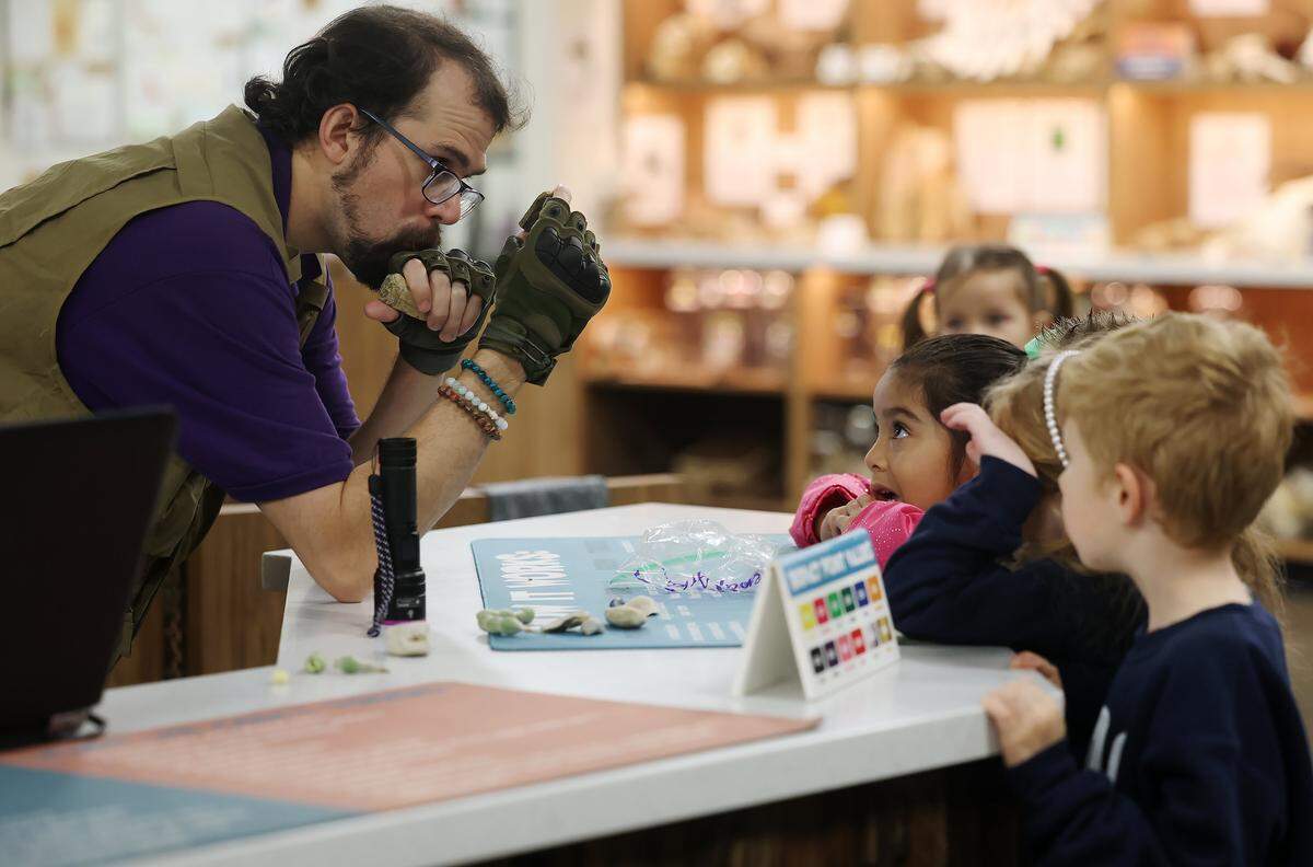 Zachary Chapman, left, looks at a specimen brought by a Nature's Navigator to the Texas Nature Traders during Zoo School on Thursday, April 30, 2026, at the Fort Worth Zoo.