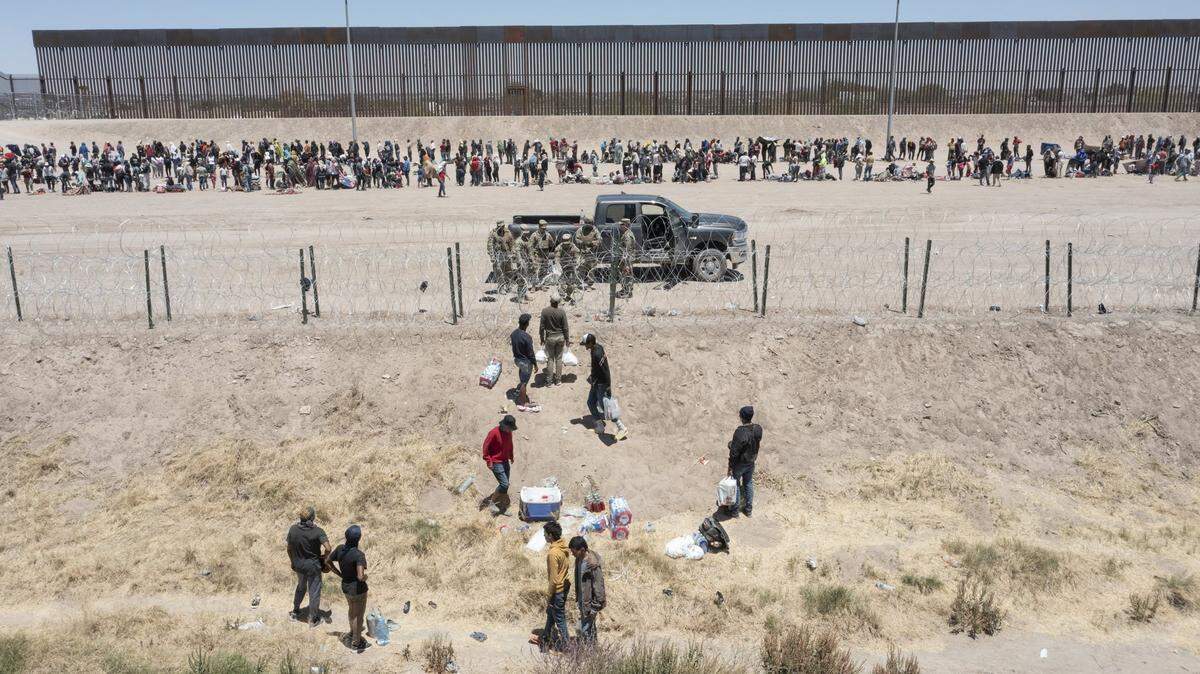 Migrants are stopped by Texas National Guard soldiers from entering the U.S. in El Paso in May. (Omar Ornelas-USA TODAY NETWORK)