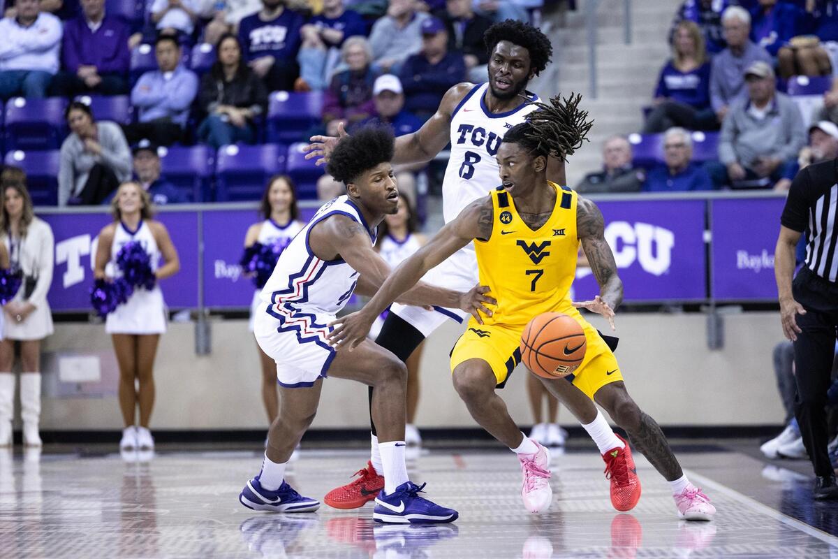 West Virginia guard Javon Small (7) is double teamed by TCU guard Jace Posey (41) and center Ernest Udeh Jr. (8) in the first half of an NCAA game between TCU and West Virginia at Schollmaier Arena in Fort Worth on Wednesday, Feb. 5, 2025.