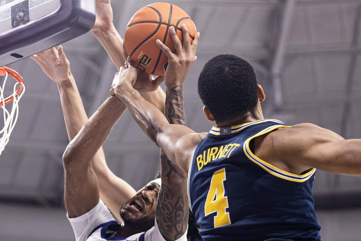 TCU guard Micah Robinson (5) goes up for a contested layup and gets hit on the wrist by Michigan guard Nimari Burnett (4) in the second half of a NCAA basketball game between the TCU Horned Frogs and the Michigan Wolverines at Schollmaier Arena in Fort Worth on Friday, Nov.14, 2025.