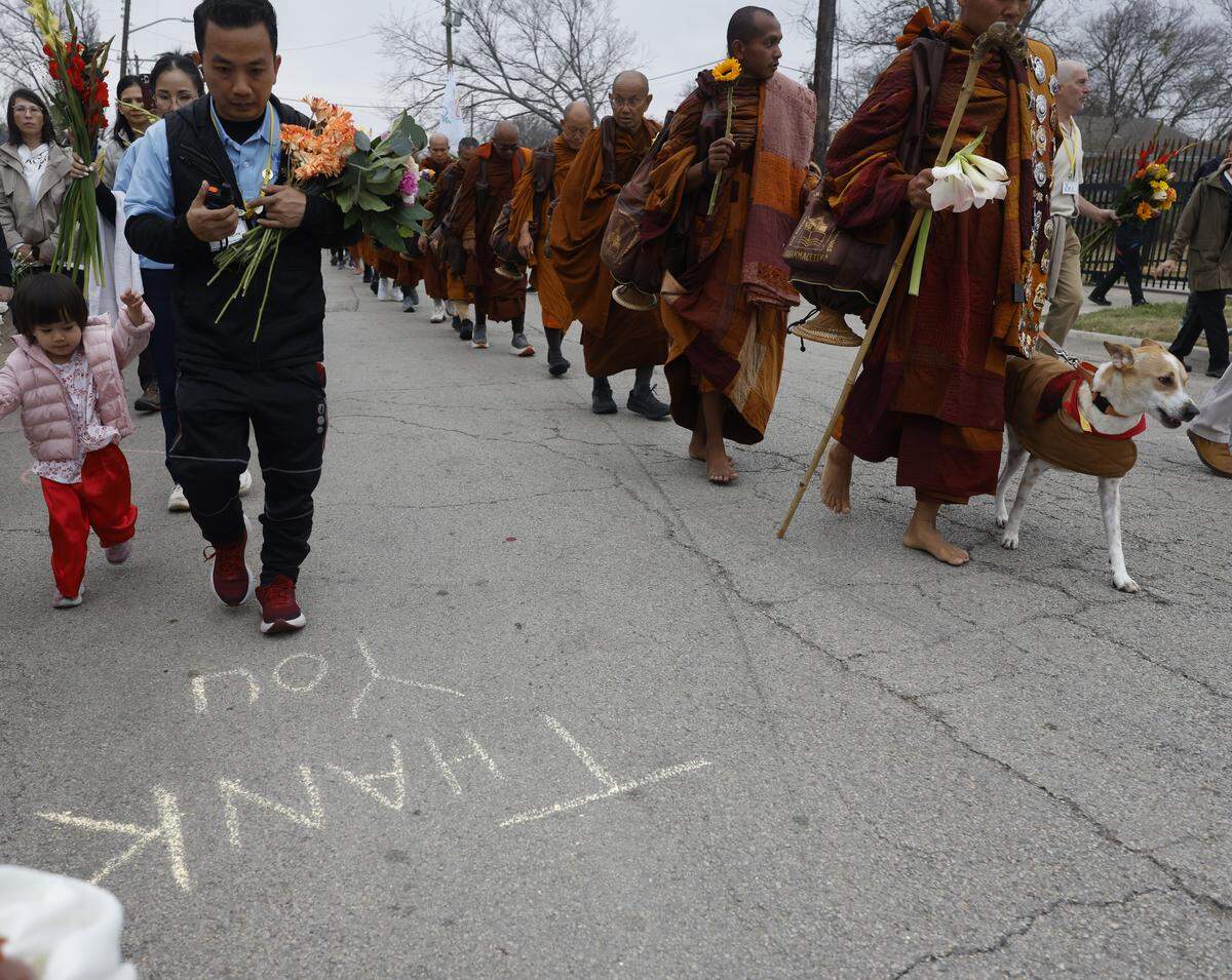 Signs of appreciation and love were scattered all along the road as Buddhist monks who walked nearly 2,300 miles to Washington D.C. for Peace arrive back to the Húóng Do Vipassana Bhavana Center in Fort Worth, Texas, Saturday Feb. 14, 2026.