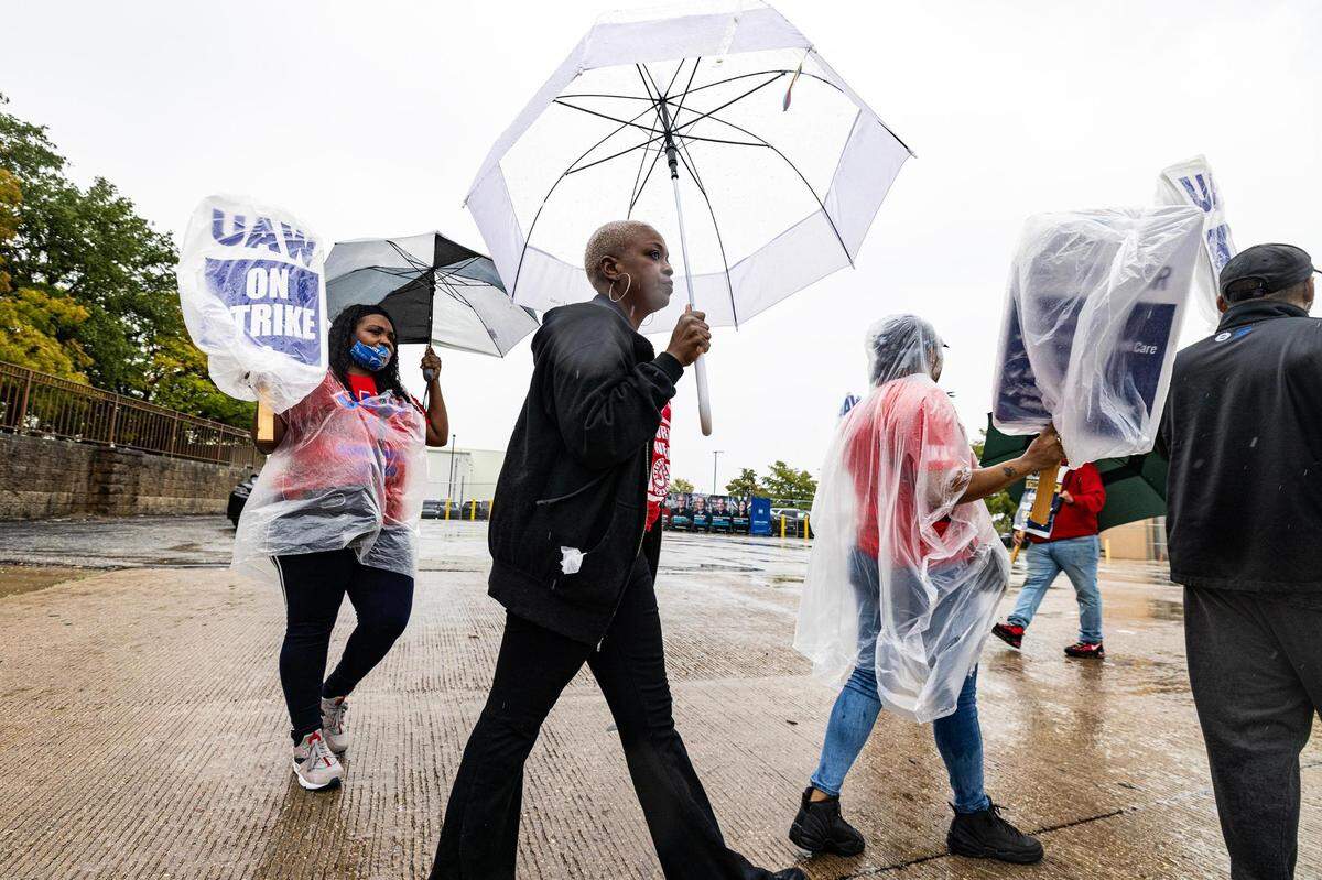 General Motors worker Khristy Magee, center, joins a group of employees on strike outside of the General Motors Assembly plant in Arlington on Tuesday, Oct. 24, 2023. More than 5,000 workers in Arlington walked off the job Tuesday morning after the United Auto Workers union called for the plant to join its strike. The UAW strike began on September 15 against the Big Three automakers — GM, Ford and Stellantis.