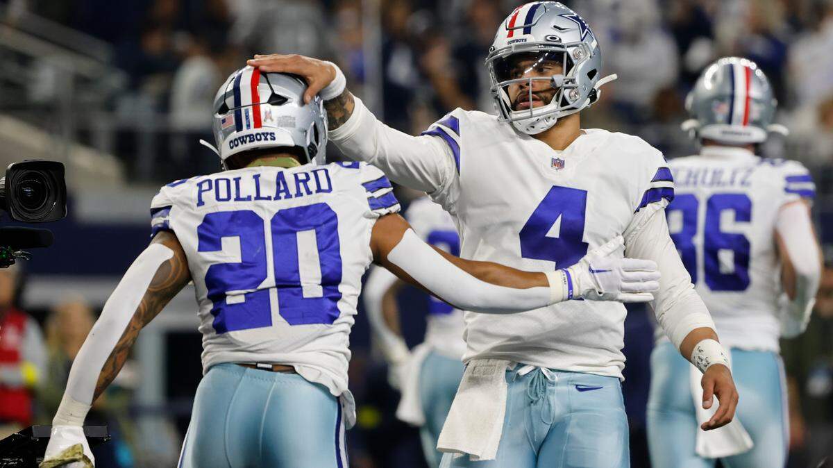 Dallas Cowboys quarterback Dak Prescott (4) reacts with Tony Pollard (20) after Pollard scored a touchdown during the first half of an NFL football game against the Indianapolis Colts, Sunday, Dec. 4, 2022, in Arlington, Texas. (AP Photo/Michael Ainsworth)