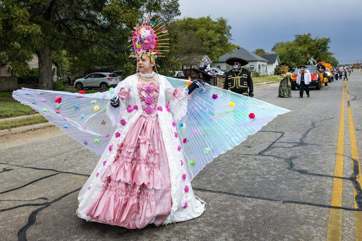 Parade participants walk down Ellis Avenue for the Dia De Los Muertos Parade in Northside Fort Worth on Saturday, Nov. 1, 2025.