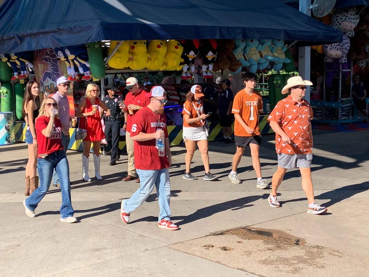 Oklahoma and Texas fans file into the State Fair of Texas a few hours before the Texas-Oklahoma football game Saturday at the Cotton Bowl in Dallas.