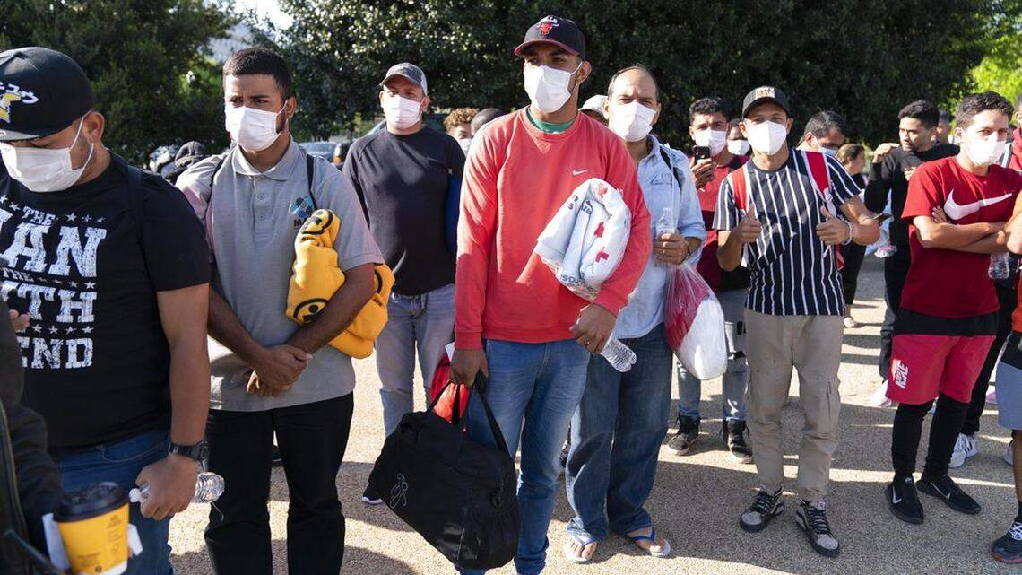 Migrants hold Red Cross blankets after arriving by bus to Union Station in Washington, D.C., from Texas on April 27. A Texas archbishop slammed leaders transporting migrants to other states.