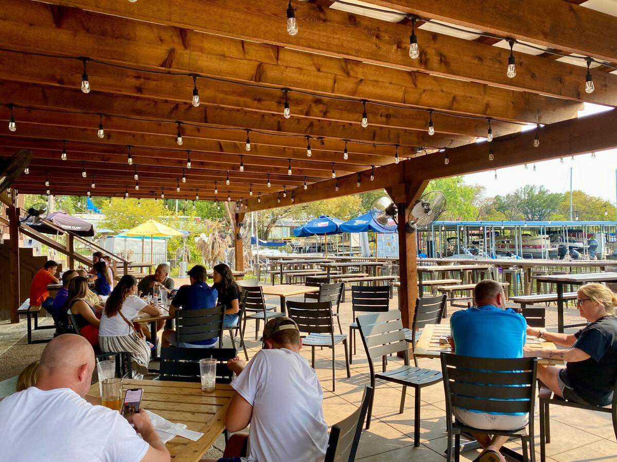 The covered deck and patio at the Lakehouse restaurant, overlooking a marina on Eagle Mountain Lake in Fort Worth, Texas, Sept. 12, 2021.