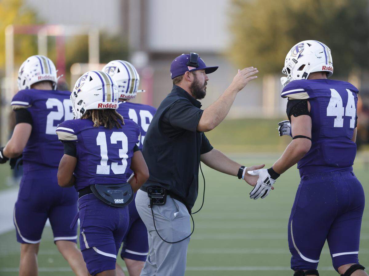 Timber Creek head coach Austin Kaehn congratulates players as they leave the field during the first half of a UIL football game between L.D. Bell and Timber Creek at Keller ISD Athletic Complex in Keller on Thursday, Sept. 11, 2025.