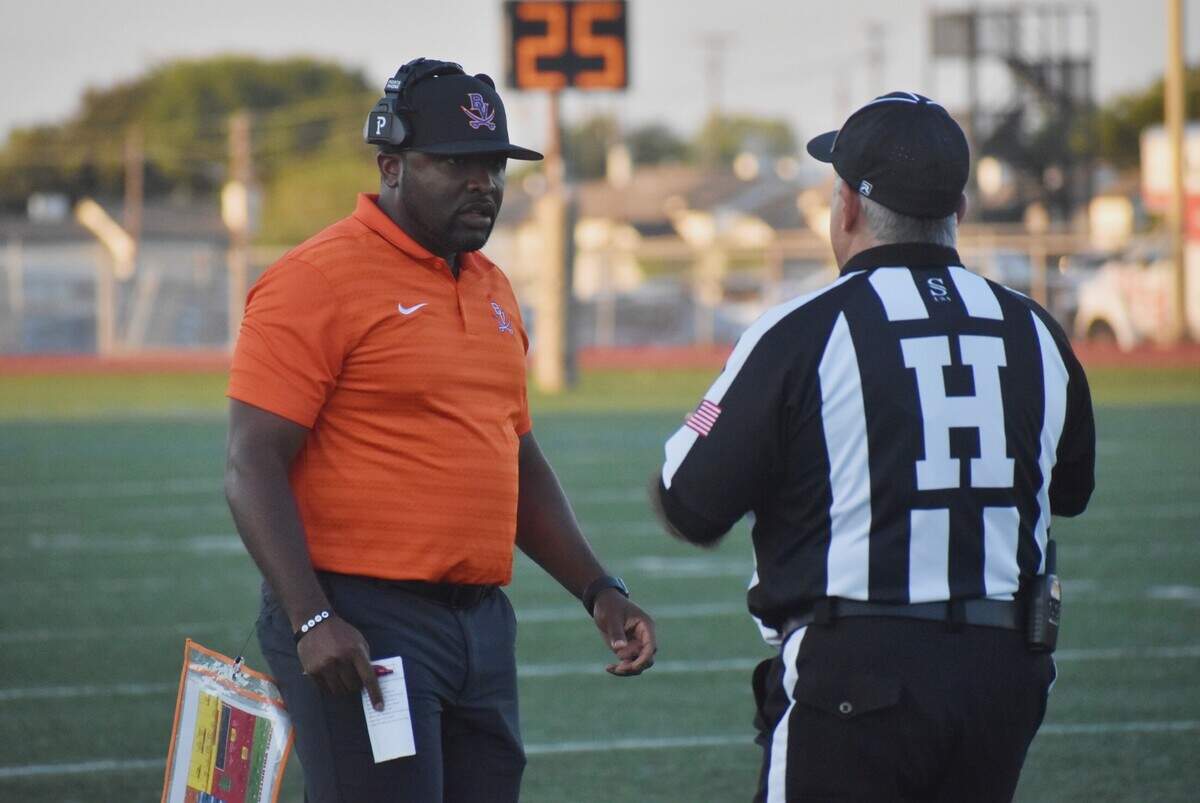Arlington Bowie coach Joseph Sam talks to an official during a UIL football game at Wilemon Field in Arlington on Friday, Sept. 19, 2024.