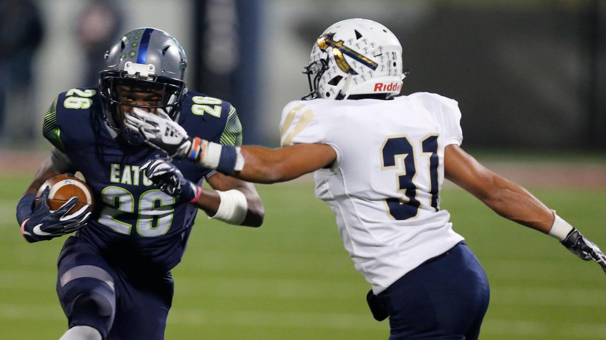 Eaton’s Isaac Jones (26) carries in the second quarter, defended by Keller’s Frank Burnell (31). The Keller Indians played the Eaton Eagles at Northwest Stadium Friday, October 11, 2019.