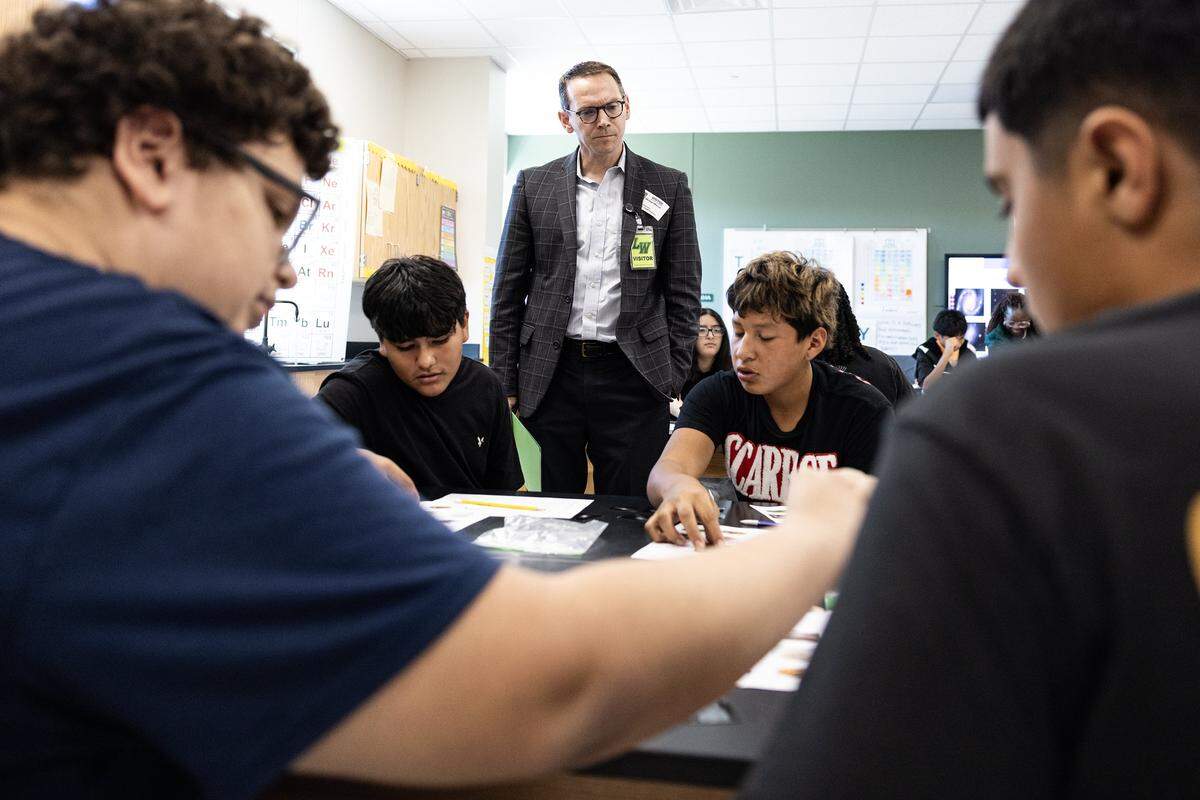 Mike Morath, the Texas Commissioner of Education, interacts with students on their classwork in a science class at Lucyle Collins Middle School in Lake Worth on Tuesday, Oct. 21, 2025.