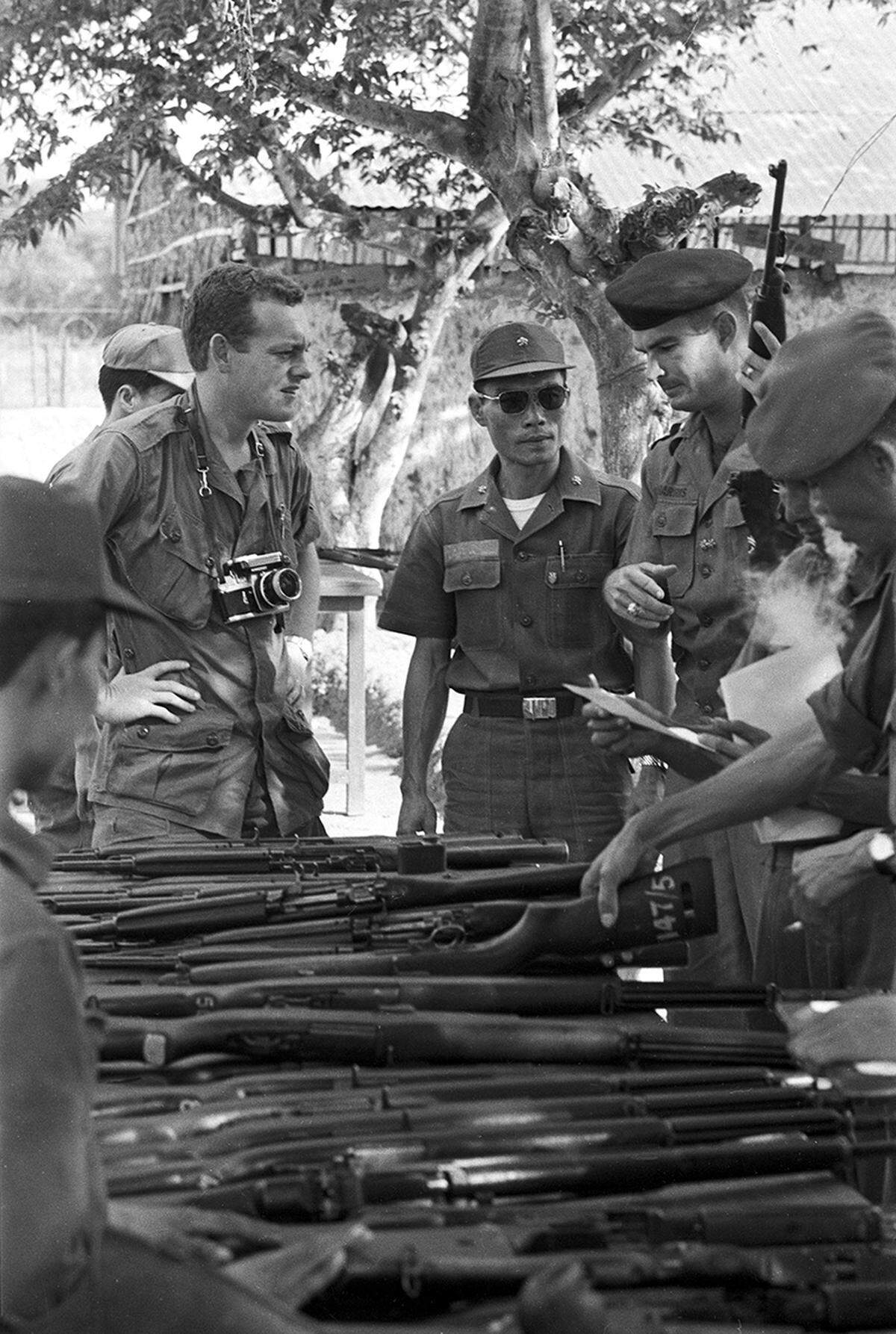 Fort Worth Star-Telegram reporter Bob Schieffer, left, speaking with U.S. Army Lt. Donald W. Harris of College Station, right, in Coa Long of the Kien Phong Province of South Vietnam during the Vietnam War. Shown with Harris is his Vietnamese counterpart, Lieutenant Be, center.