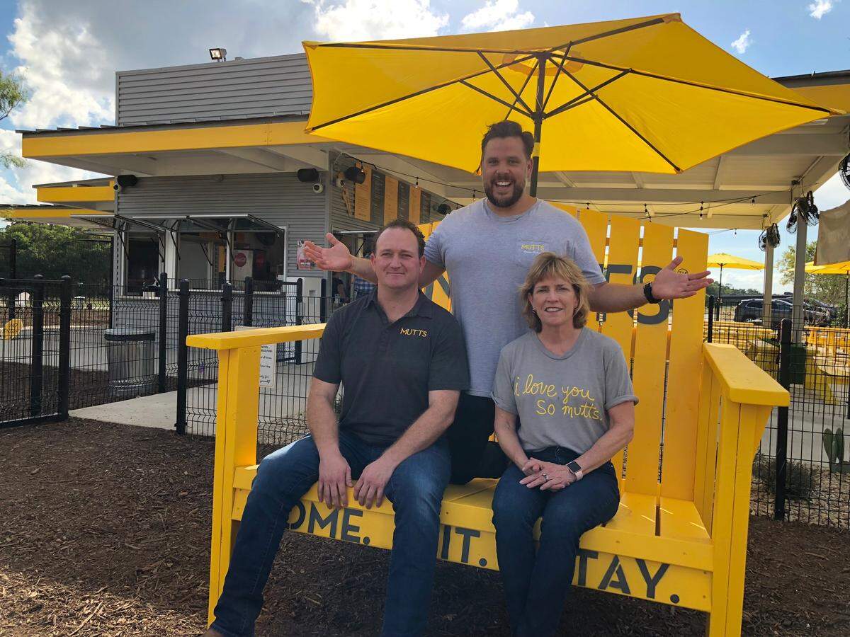 Mutts Canine Cantina co-founders Josh Sepkowitz (seated) and Kyle Noonan, with managing partner Michelle Boggs. Dallas=based Mutts, an “urban oasis for dogs and their owners,” opened a Fort Worth location in October.