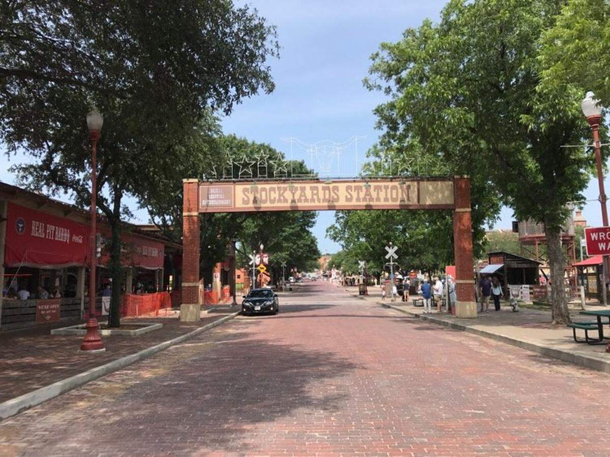 Groups of people walk through Fort Worth’s Stockyards on Saturday morning during the Memorial Day weekend, which was emptier than it would’ve been on a holiday weekend before the coronavirus. Businesses had to cap capacity at 25 percent and there were hand-sanitizing stations available.
