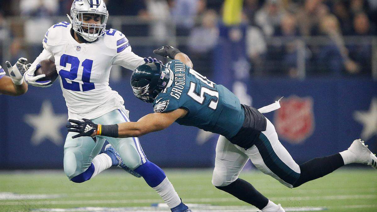 Philadelphia Eagles outside linebacker Kamu Grugier-Hill (54) makes a diving tackle of Dallas Cowboys running back Ezekiel Elliott (21) in the first quarter on Sunday, Dec. 9, 2018 at AT&T Stadium in Arlington, Texas.
