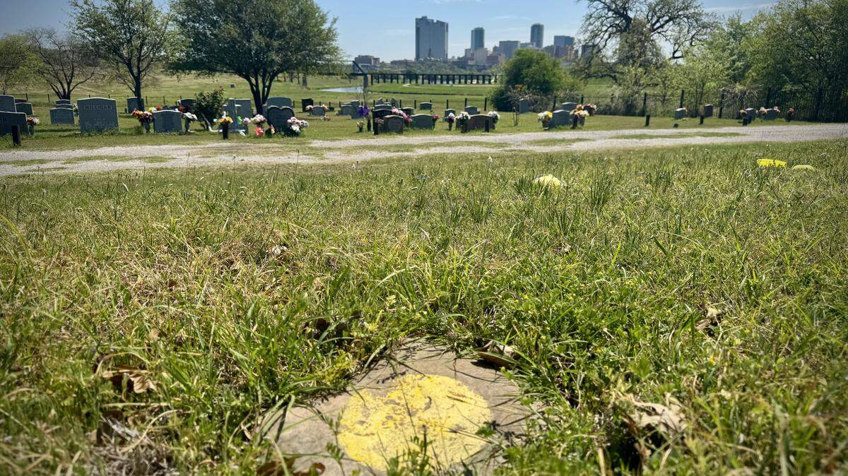 A simple stone with a yellow circle at Oakwood Cemetery marks the grave of an Indigenous woman whose remains were discovered during construction in downtown Fort Worth in 2016. Before she was buried in December 2017, experts determined she had been in her 30s when she died more than 1,000 years ago.
