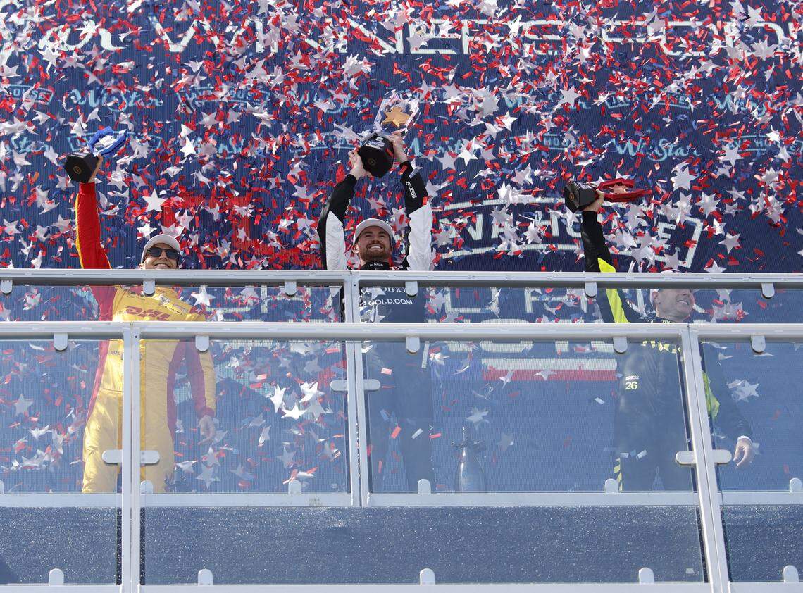 Second place, Alex Palou (10), first place Kyle Kirkwood (27) and third place Will Power (26) celebrate after the inaugural Java House Grand Prix of Arlington in Arlington, Texas, Sunday, March, 15, 2026.