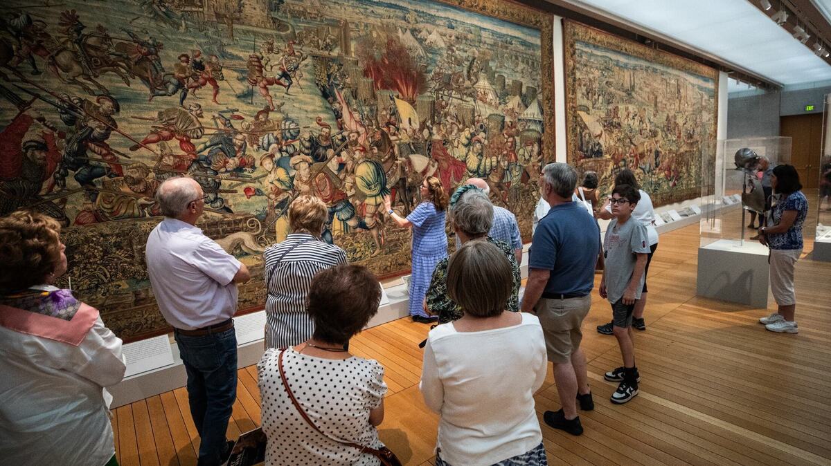 A guide describes an art piece that is part of the “Art and War in the Renaissance: The Battle of Pavia Tapestries” exhibit on Friday, June 14, 2024, at the Kimbell Art Museum. The tapestries featured at the event depicted moments during the Battle of Pavia in 1515.