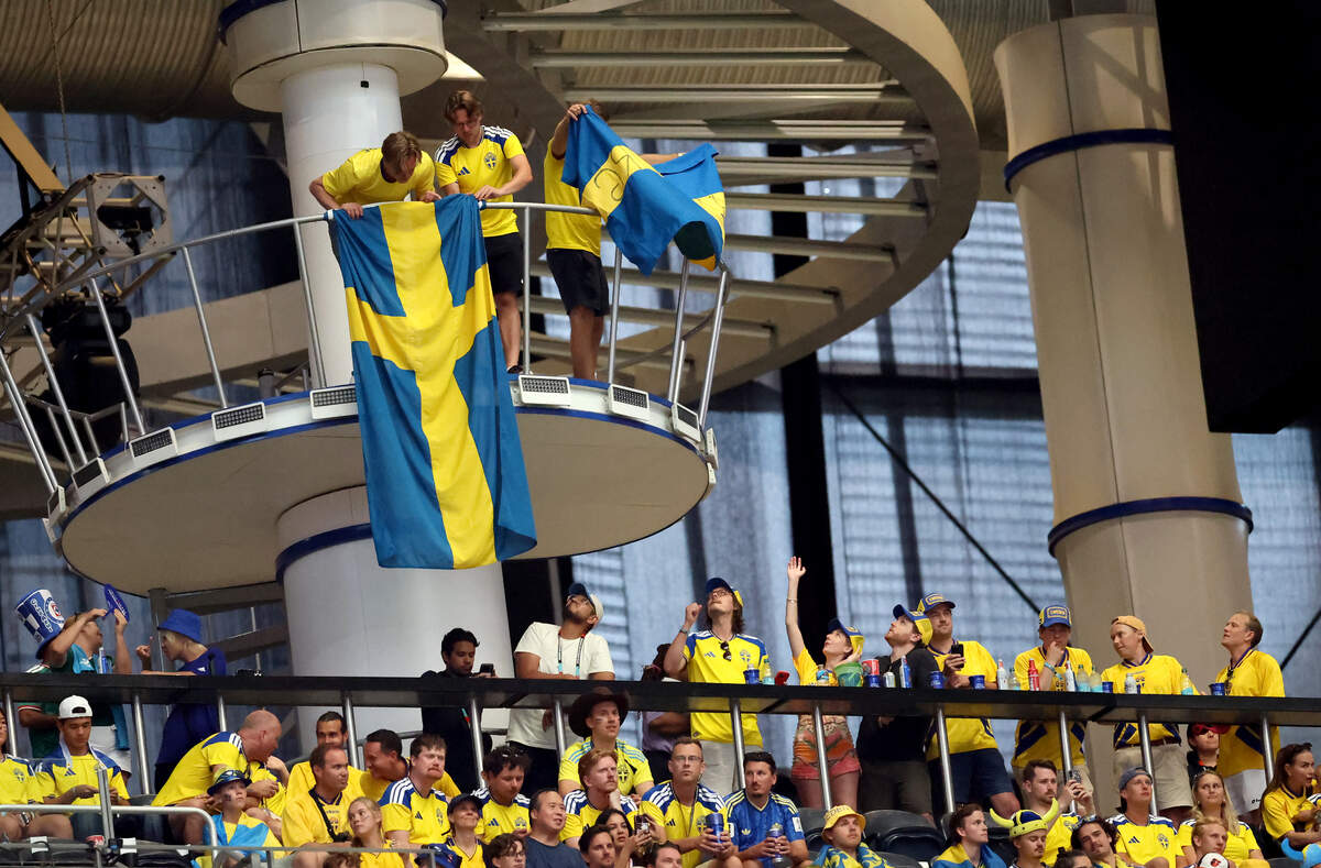 Sweden fans hang flags in the upper concourse of Dallas Stadium during the FIFA World Cup 2026 group stage match between Japan and Sweden on Thursday, June 25, 2026, at Dallas Stadium in Arlington. The curtains were down for the match, as seen, to avoid glare.