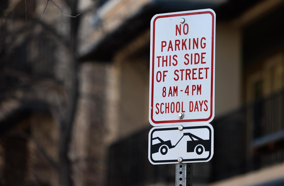 A sign on Sandage Avenue near TCU  alerts drivers to a no-parking zone on the west side of the street between 8 a.m. and 4 p.m on school days in Fort Worth.