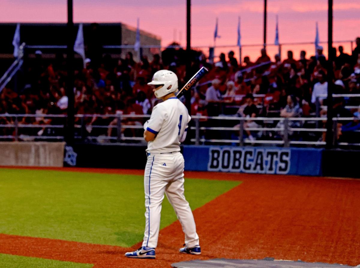The sun sets behind Byron Nelson third baseman Colton Smith (4) as he prepares to bat during a UIL Regional Seminal 6A D2 baseball playoff game at Bobcat Field in Trophy Club, Texas, Thursday, May 15, 2025.