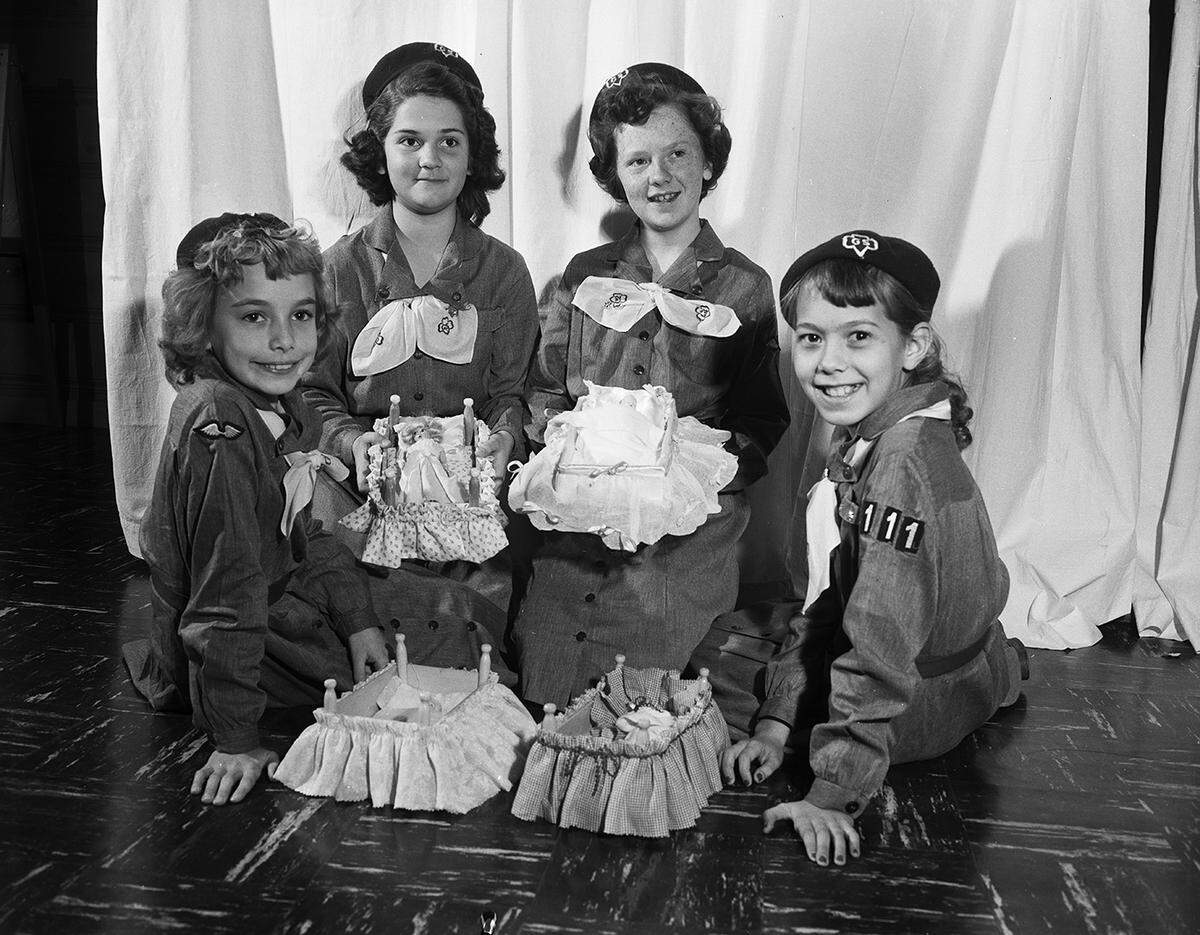 Dec. 15, 1953: Four Girl Scouts from Troop 111 display the gifts their troop presented to Tarrant County Children’s Home. Left to right are Vicki Parrott, Sharon Tuohy, Kay Mullendore and Carolyn Forbes. The four were among 15 Girl scouts making doll beds for the home.