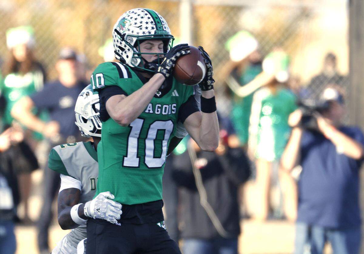 Southlake Carroll wide receiver Brody Knowles (10) grabs a pass in front of a DeSoto defender during the first half of a UIL Class 6A Division II semifinal on Saturday Dec. 13, 2025 at Vernon Newsom Stadium in Mansfield, Texas.