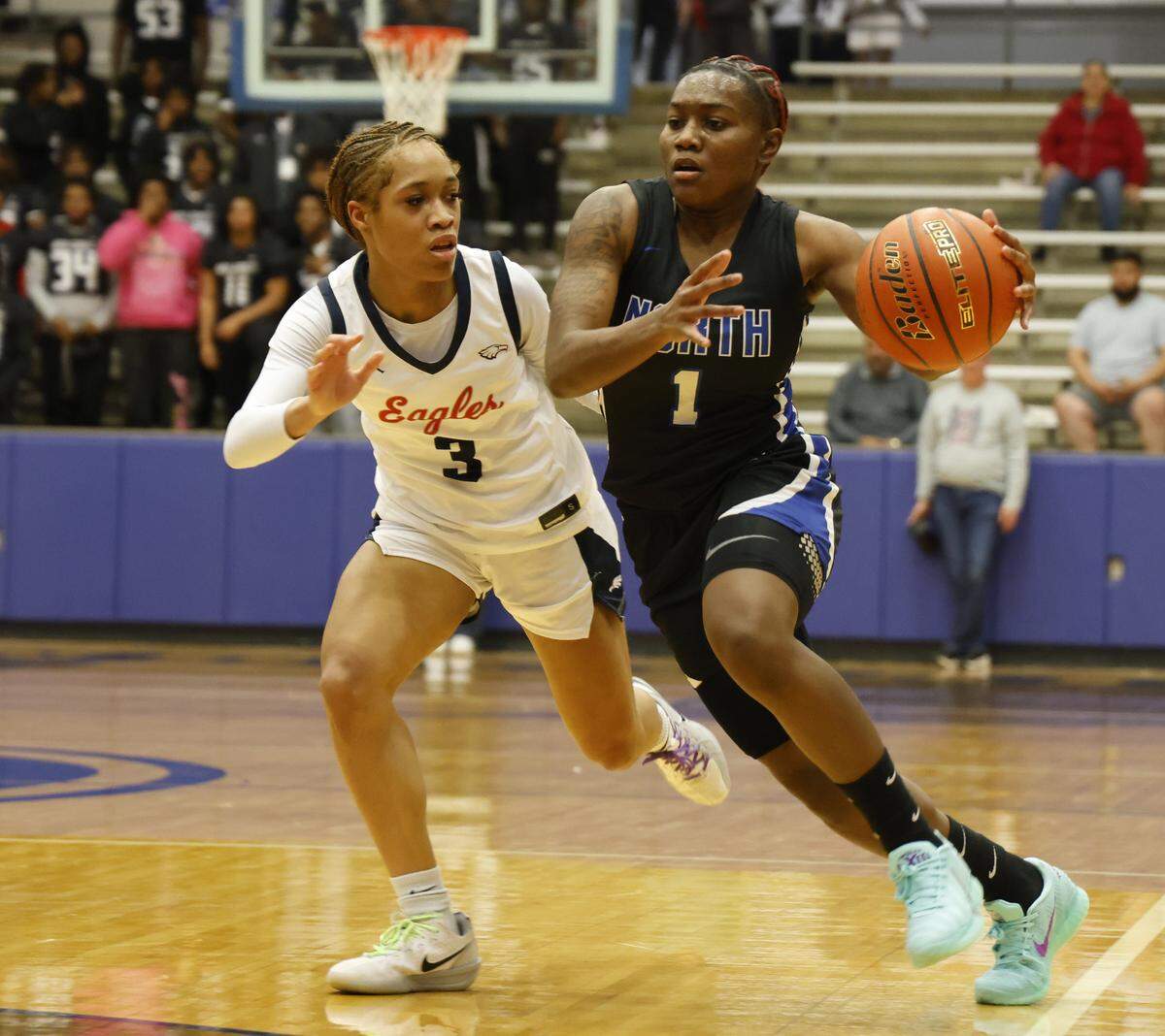 North Crowley guard Jamari Milton (1) drives in against Allen guard Kyndal Jones (3) during the first half of a UIL Class 6A Division I girls regional semifinals basketball playoff game at Grand Prairie High School in Grand Prairie, Texas, Tuesday Feb. 24, 2026.