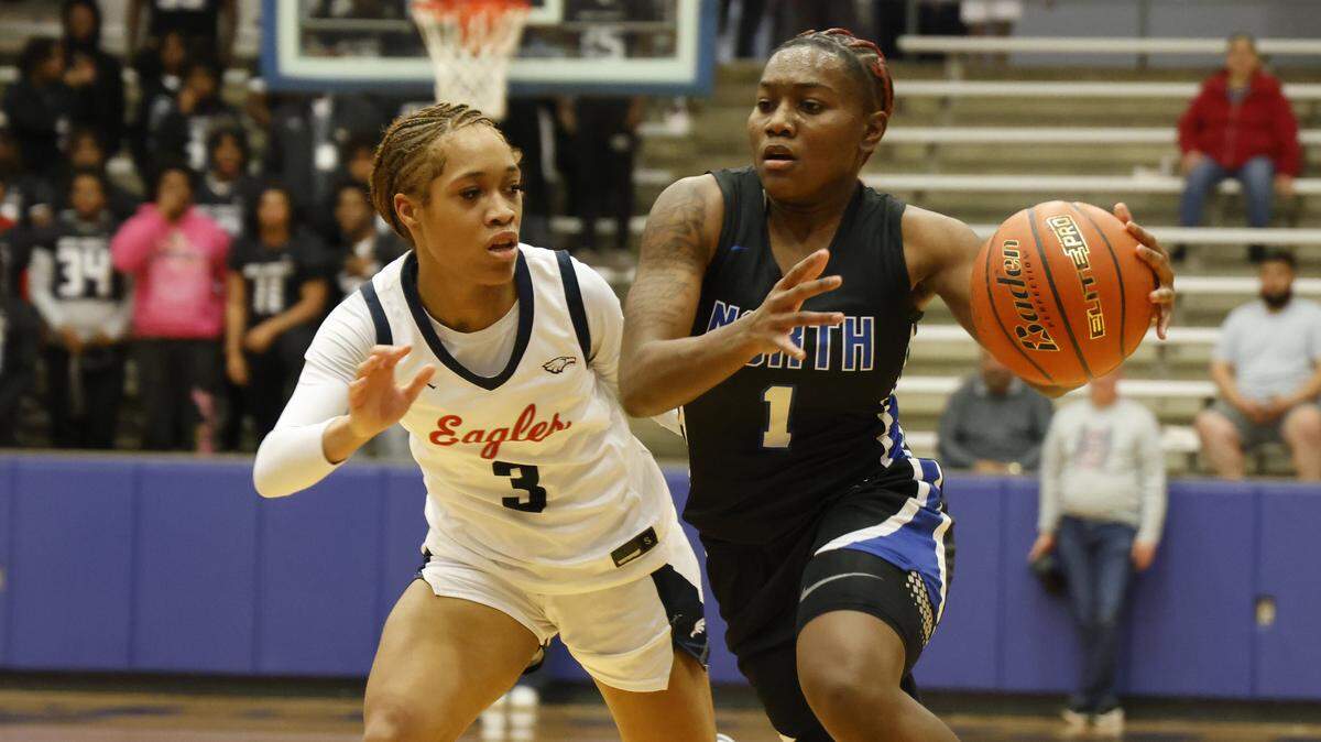 North Crowley guard Jamari Milton (1) drives in against Allen guard Kyndal Jones (3) during the first half of a UIL Class 6A Division I girls regional semifinals basketball playoff game at Grand Prairie High School in Grand Prairie, Texas, Tuesday Feb. 24, 2026.
