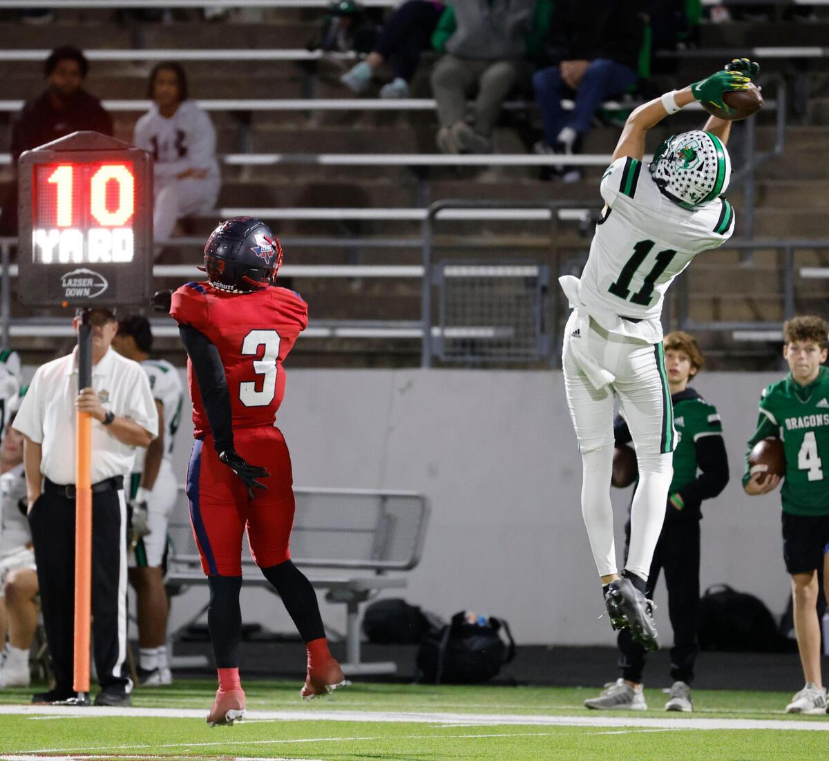 Southlake wide receiver Brock Boyd (11) grabs a touchdown pass over the head of Northwest defensive back Jayden Harrington (3) during a District 4 6A football game at Northwest ISD Stadium in Justin, Texas, Thursday, Oct. 17, 2024.