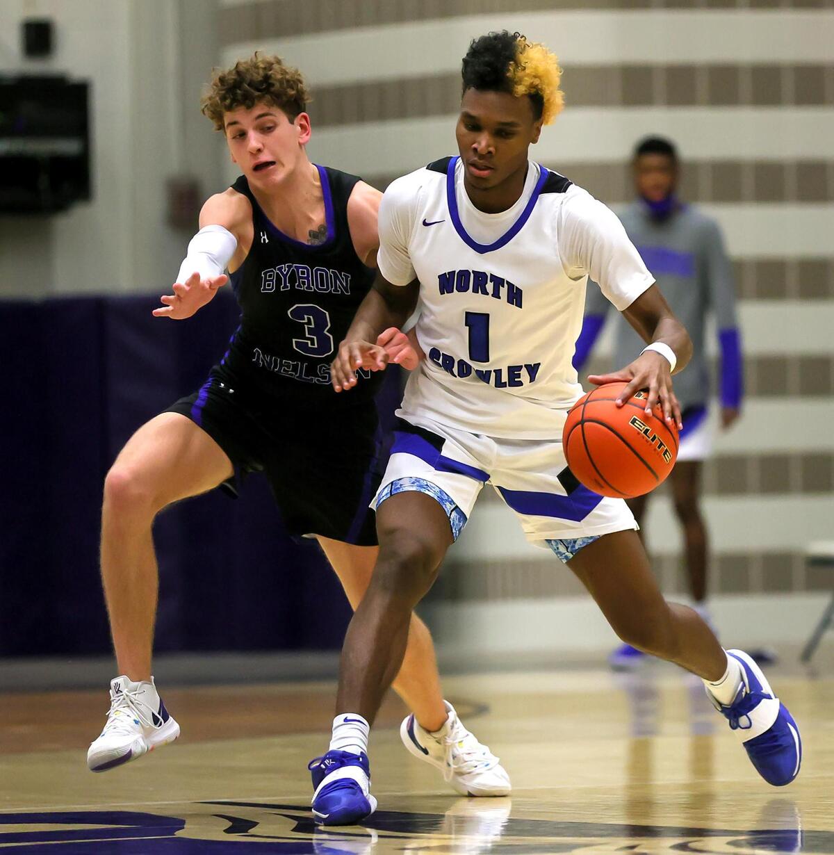 North Crowley forward Marques Sales (1) is defended by Byron Nelson guard Finley Bizjack (3) during the second half, Friday, February 26, 2021 of a 6A Region 1 Quarterfinal High School playoff Basketball game played at the Thomas Coliseum in Haltom City, Tx. (Steve Nurenberg Special to the Star-Telegram)