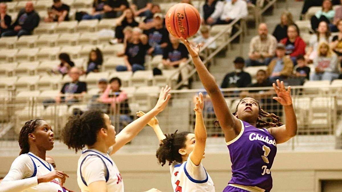 Fort Worth Chisholm Trail’s Kennedy Brooks (3) goes up in front of Grapevine’s Selah Stull (5), Adia Stull (14) and Ella Kamara (7) in a UIL girls Class 5A Division II bi-district game on Monday, February 16, 2026 at Thomas Coliseum in Haltom City, Texas. Grapevine defeated Chisholm Trail 56-47.
