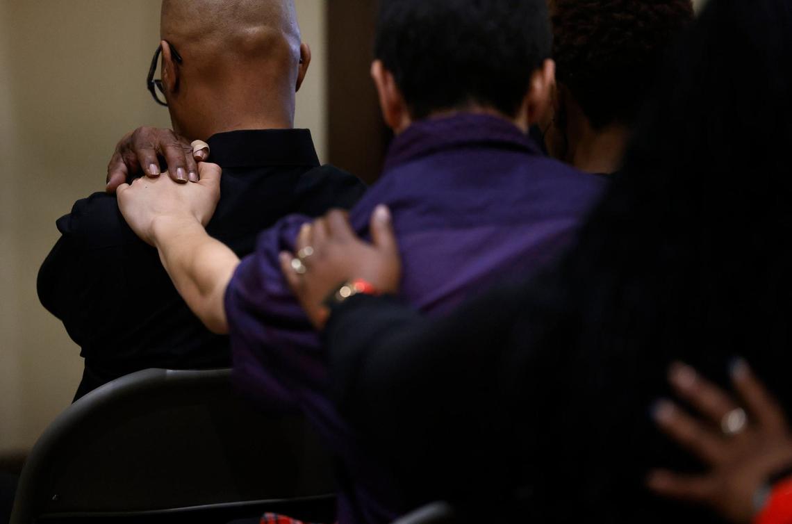 Family and friends touch each other during prayer at Anthony Johnson Jr.’s funeral on Friday, May 24, 2024, in Mansfield. Johnson was killed while in custody at the Tarrant County Jail in April.