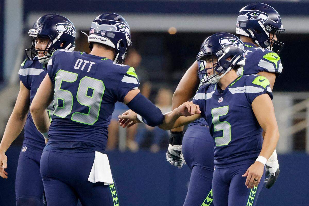 Seattle Seahawks’ Tyler Ott (69) and Jason Myers (5) celebrate after Myers kicked a field goal in the first half of a preseason NFL football game against the Dallas Cowboys in Arlington, Texas, Friday, Aug. 26, 2022. (AP Photo/Michael Ainsworth)