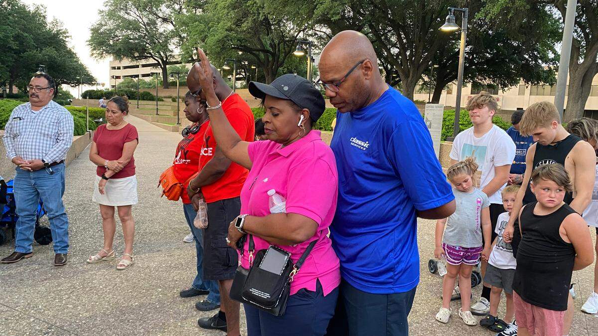 Demonstrators gathered Sunday night at the Water Gardens in downtown Fort Worth during a vigil for the victims of last week’s mass shooting in Uvalde.