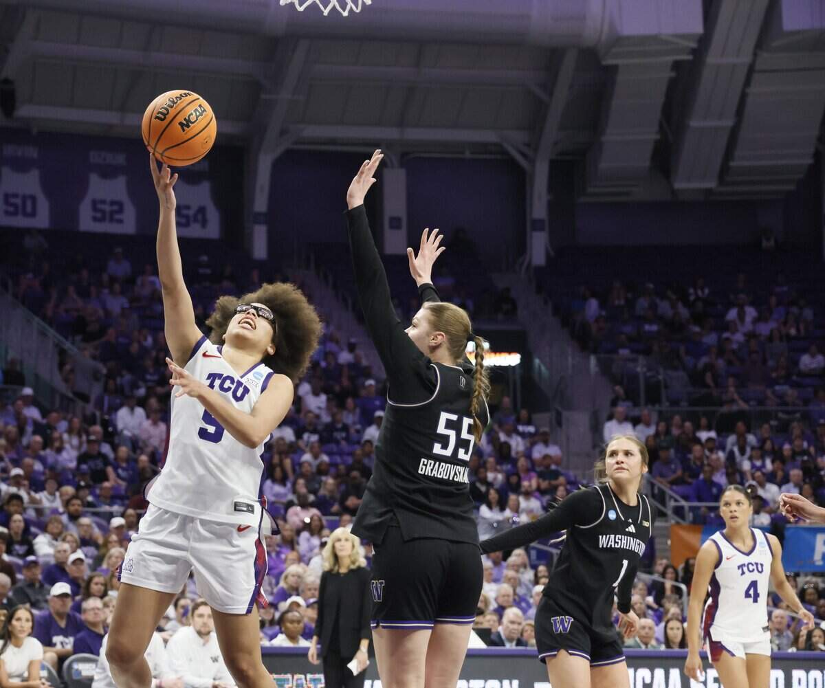 TCU guard Olivia Miles (5) puts in a soft shot over Washington center Yulia Grabovskala (55) during the first half of a second round NCAA Division I Women's Basketball Championship game at Schollmeier Arena in Fort Worth, Texas, Sunday, March, 22, 2026.