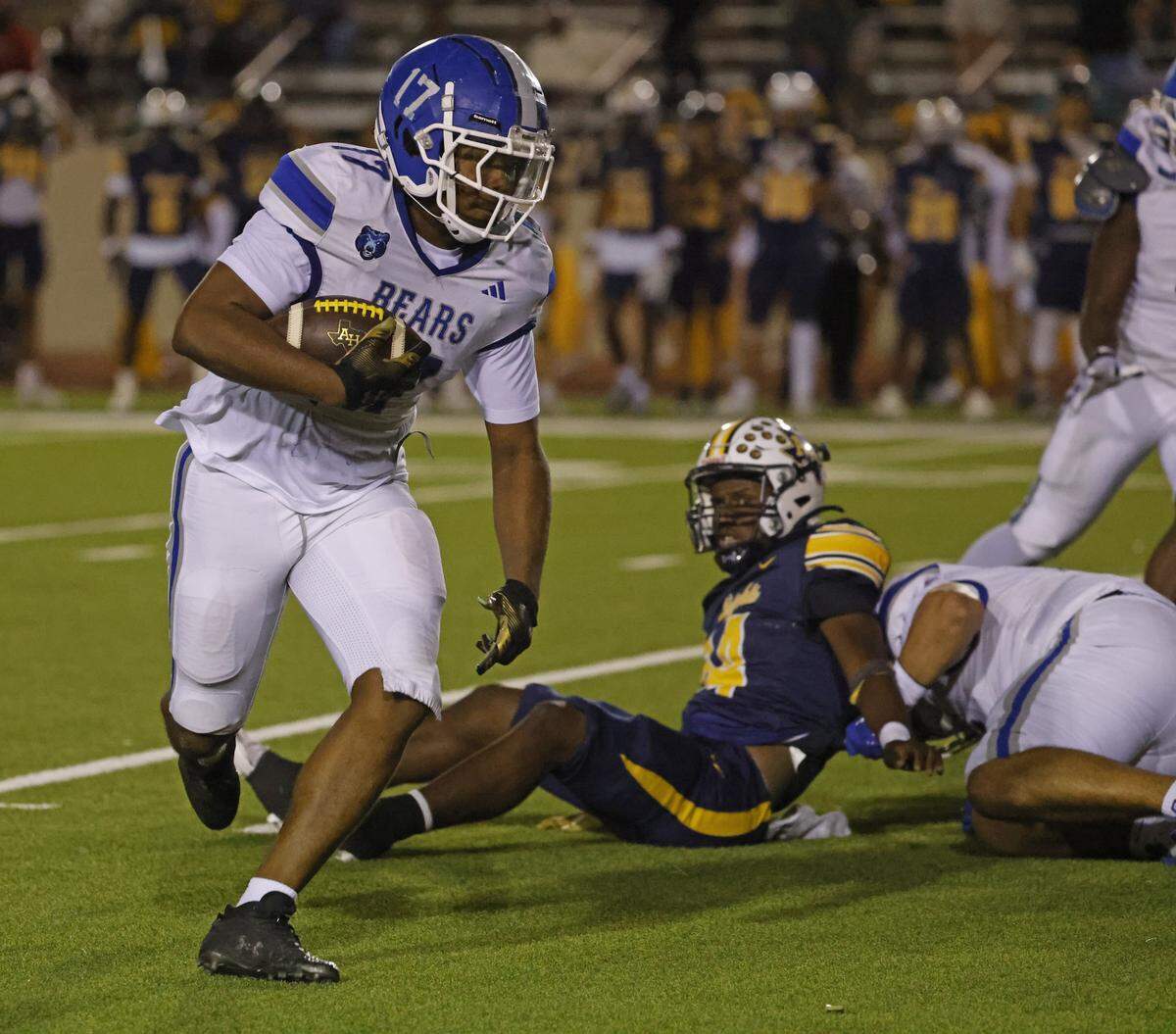 Brewer linebacker Kingston Hurst (17) returns a fumble he caught in mid air for a touchdown during the first half of a UIL Conference 5A D1 Bi-District playoff game between Arlington Heights and Brewer at Farrington Field in Fort Worth, Texas, Friday, Nov. 14, 2025.