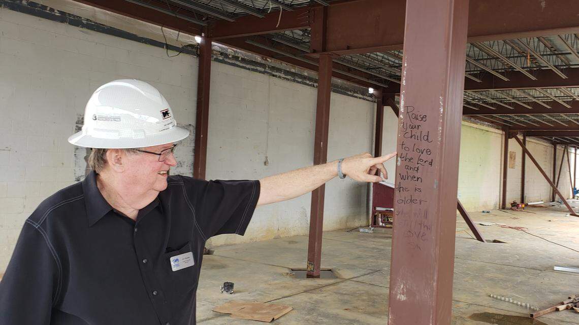 Jim Reeder with the Arlington Life Shelter shows a beam that has a special message written on it by a visitor to the site of the Hearts to Homes expansion project for ALS. The nonprofit organization is temporarily relocating services to two faith-based partner facilities until the project is completed.