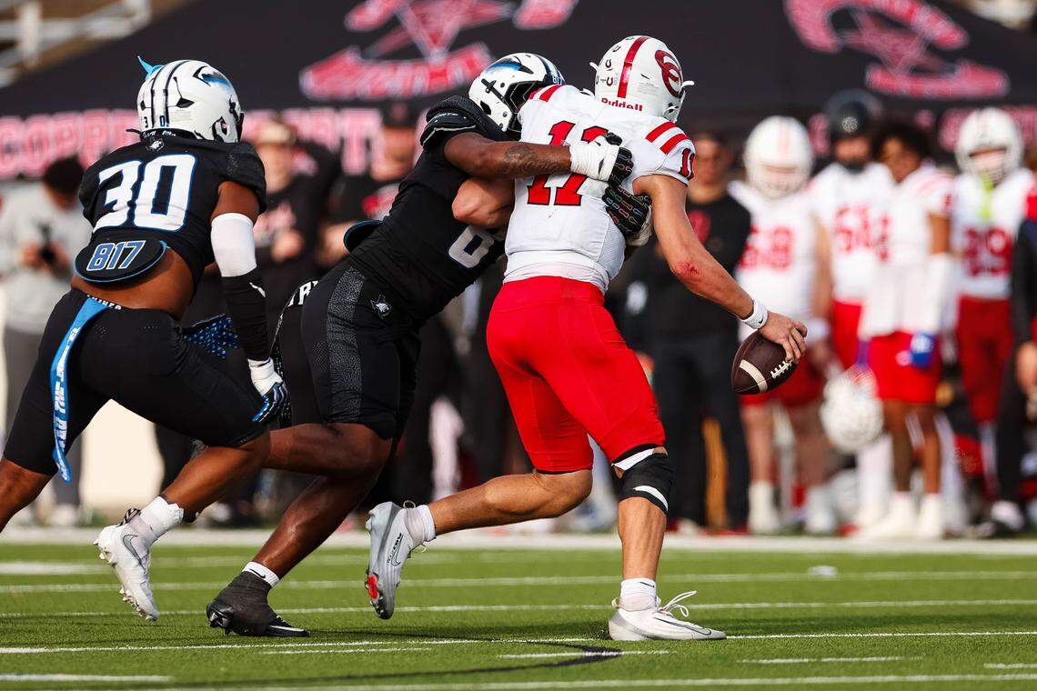 North Crowley defensive lineman DeMorey Beasley (8) attempts to tackle Coppell quarterback Carter Zingelmann in a Class 6A Division I regional playoff Saturday, Nov. 29, 2025, at Midlothian ISD Stadium in Midlothian.