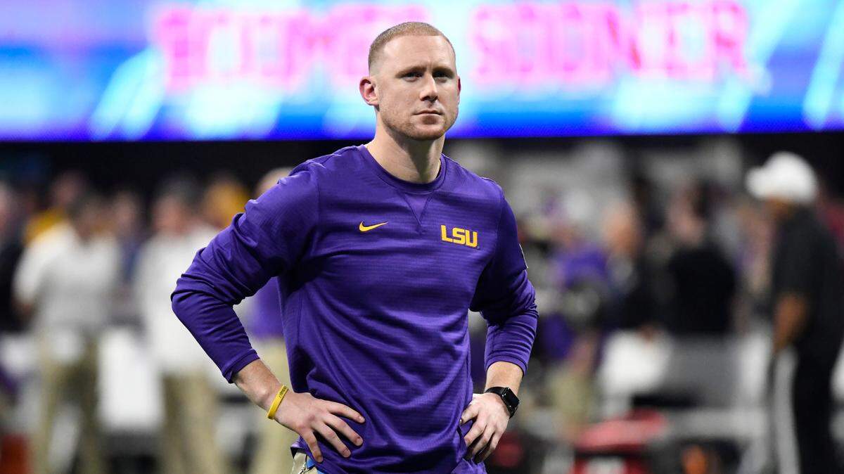 LSU offensive coach Joe Brady watches his team warm up before the first half of the Peach Bowl NCAA semifinal college football playoff game between LSU and Oklahoma, Saturday, Dec. 28, 2019, in Atlanta. (AP Photo/Danny Karnik)