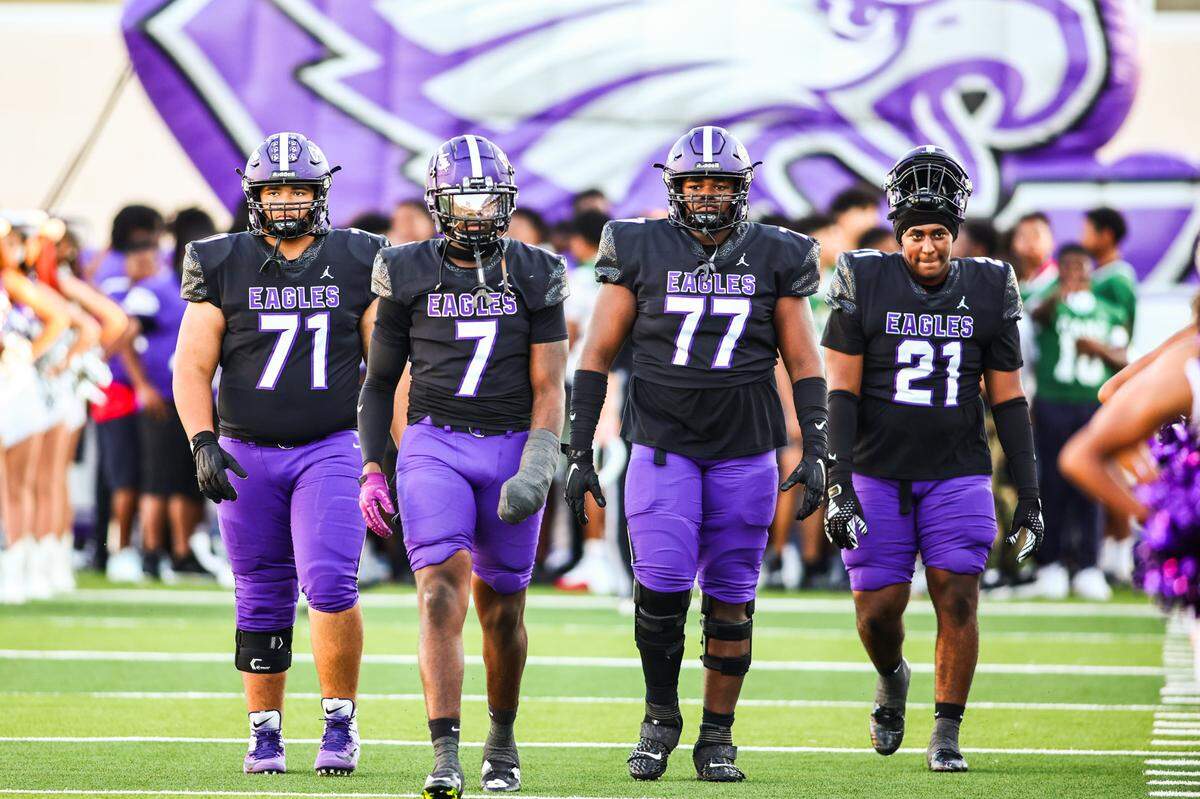 The Crowley captains walk out to the coin flip before Thursday’s game against Dallas Skyline at Crowley ISD Multi-Purpose Stadium in Fort Worth.