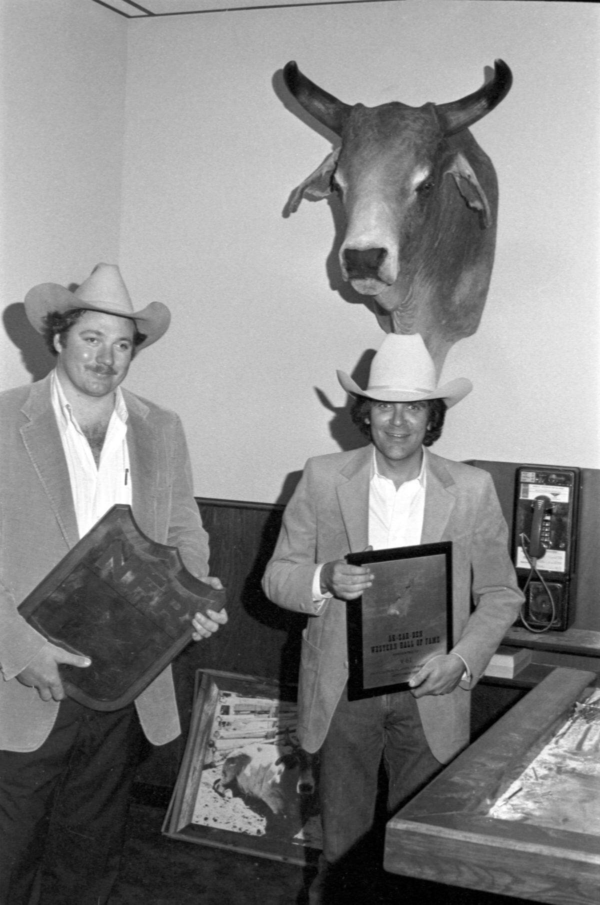 April 5, 1981: In the VIP Club at Billy Bob’s Texas, Billy Bob Barnett, left and Spencer Taylor stand before the head of V61, Bull of the Year in National Finals Rodeo of 1970, who went nine years without anyone able to ride him.