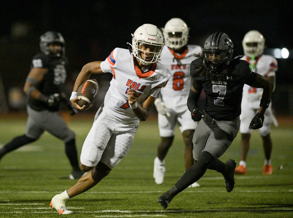 Bowie Volunteer quarterback Larry Nichols (7) runs past defenders during a UIL football game against Martin High School at Cravens Field in Arlington, Texas on Friday, Oct. 11, 2024