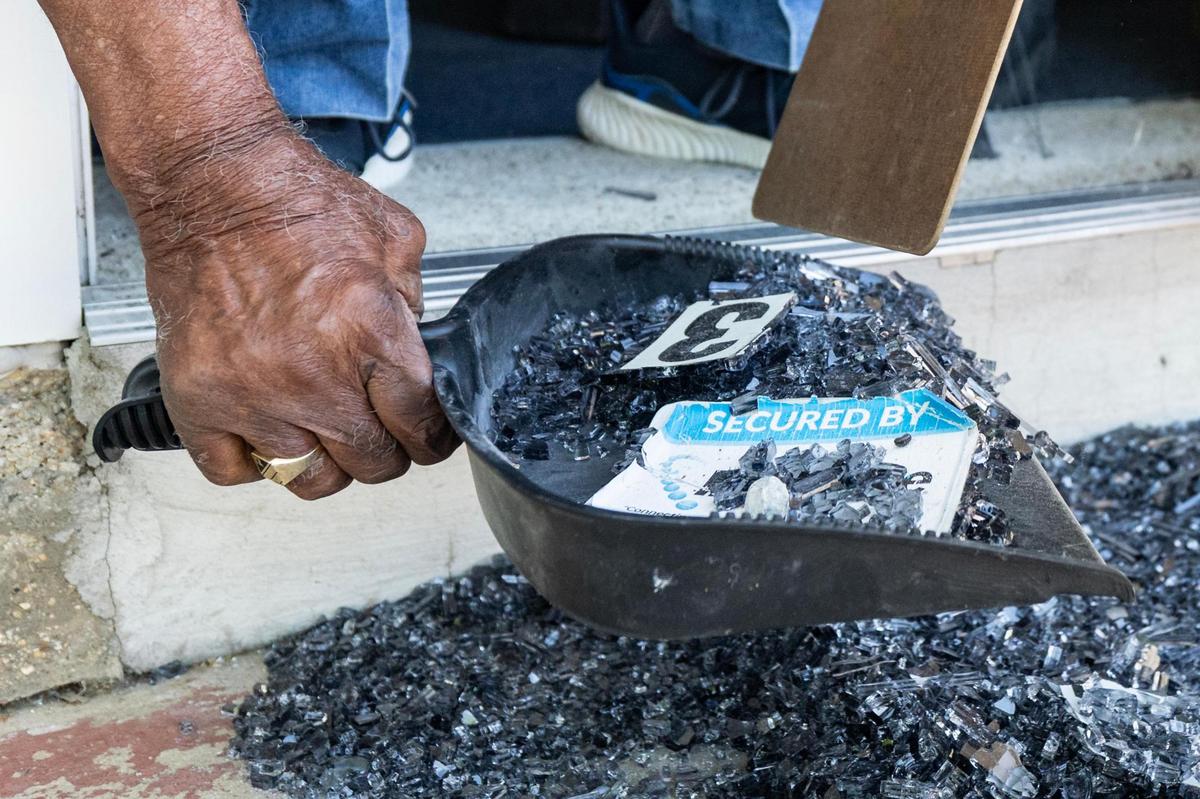 James Mallard, a lifetime member of the NAACP Fort Worth Chapter, cleans up broken glass from one of the vandalized doors of the Fort Worth Tarrant County NAACP building in Fort Worth on Tuesday, April 15, 2025.