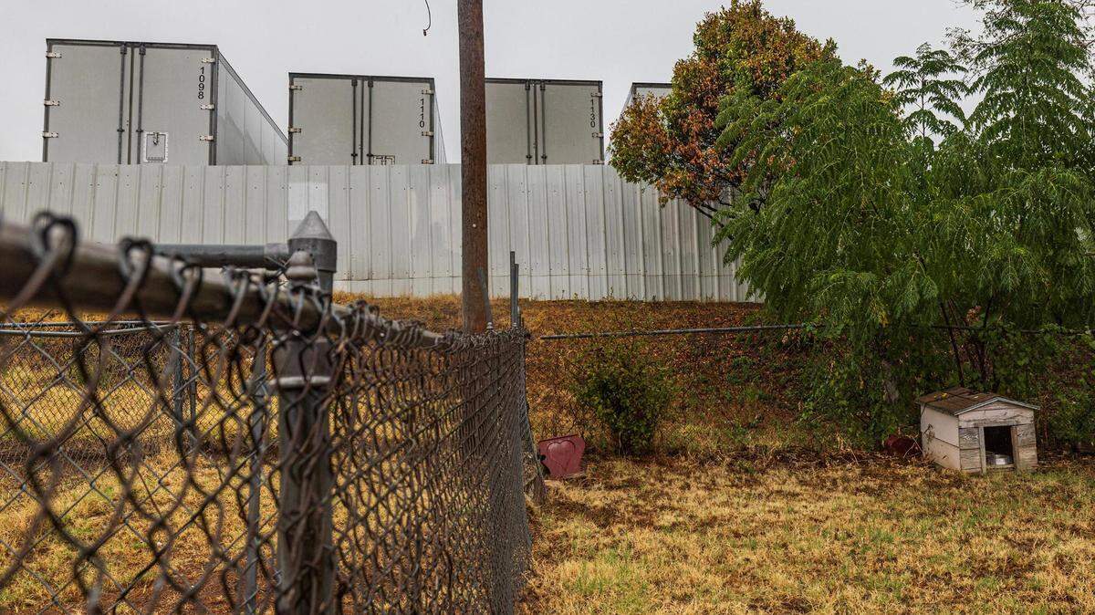 Multiple semi-trucks are parked adjacent to the backyard of Echo Heights resident Letitia Wilbourn. Wilbourn says the trucking company has contributed to air and noise pollution in her neighborhood.